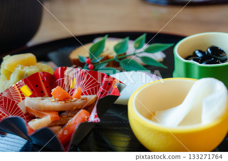 A gorgeous New Year's dinner table with ozoni and osechi dishes arranged on a half-moon tray A gorgeous New Year's dinner table with ozoni and osechi dishes arranged on a half-moon tray 133271764