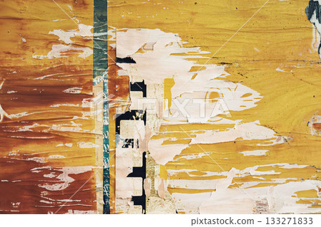 Bright torn posters fragments with bold orange and yellow tones on aged wall. Background of raw visual noise, timeworn advertising, and urban expression 133271833
