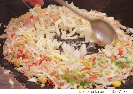 Cooking monjayaki on a hot plate 133271883