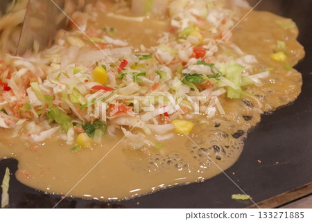 Cooking monjayaki on a hot plate 133271885
