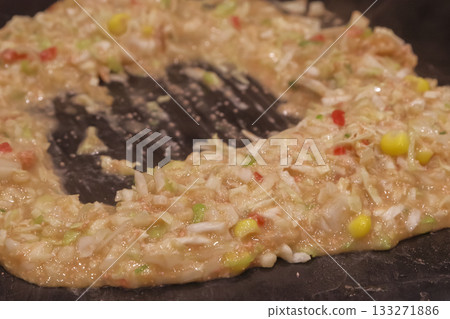 Cooking monjayaki on a hot plate 133271886