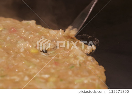 Cooking monjayaki on a hot plate Cooking monjayaki on a hot plate 133271890