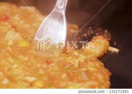 Cooking monjayaki on a hot plate 133271891