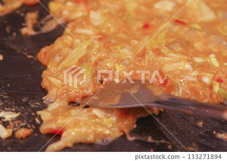 Cooking monjayaki on a hot plate 133271894