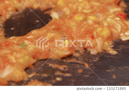 Cooking monjayaki on a hot plate Cooking monjayaki on a hot plate 133271895