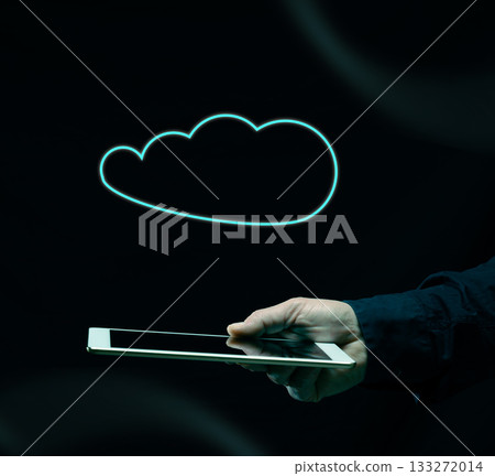 Hand holds a white tablet with a neon cloud outline glowing above it. Hand holds a white tablet with a neon cloud outline glowing above it. 133272014