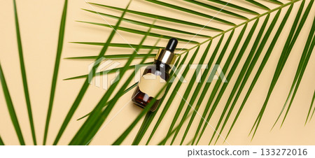 Brown glass bottle with a pipette and with blank paper label on a brown background Brown glass bottle with a pipette and with blank paper label on a brown background 133272016