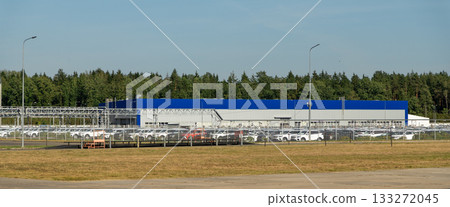 Aerial view of a vast parking lot filled with newly manufactured cars 133272045