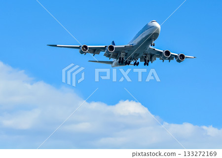 A jumbo jet takes off and flies overseas A jumbo jet takes off and flies overseas 133272169