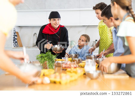 Cooking class, culinary, food and people concept - happy group of children and male chef cook cooking in modern kitchen 133272861