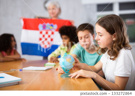 students listen to woman teacher who talks about Croatia students listen to woman teacher who talks about Croatia 133272864