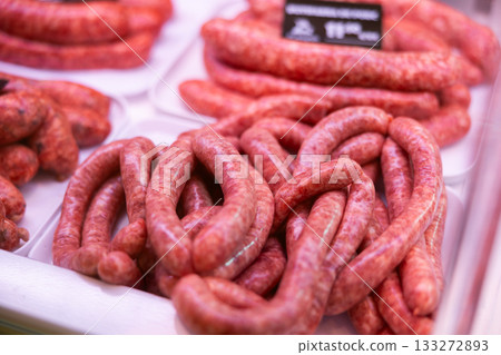 Sausages made of pork and chicken minced meat ready for grilling in meat shop Sausages made of pork and chicken minced meat ready for grilling in meat shop 133272893