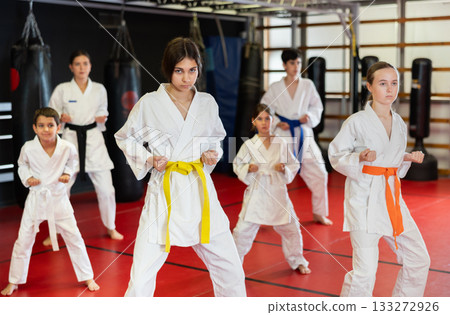 Group of children and teenagers practice karate Group of children and teenagers practice karate 133272926