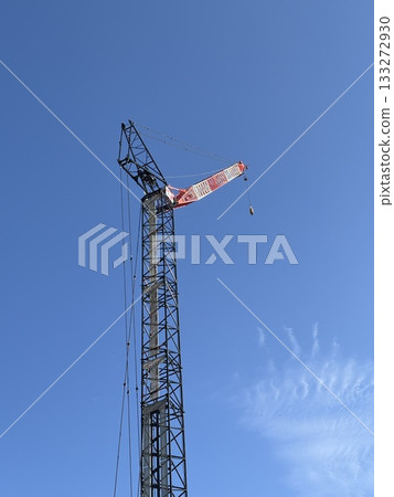 A crane extending into the blue sky 133272930