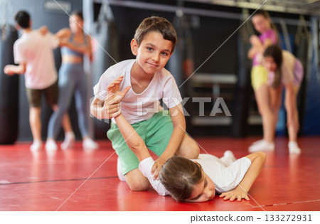 Boy and girl practice self-defense in pairs Boy and girl practice self-defense in pairs 133272931