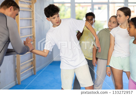 Coach and boy training self-defense techniques 133272957