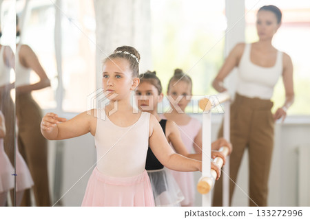 Lesson for little ballerinas - girls learn to dance ballet in choreographic class 133272996
