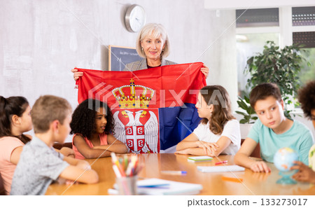 Mature woman teacher tells pupils the history of Serbia Mature woman teacher tells pupils the history of Serbia 133273017