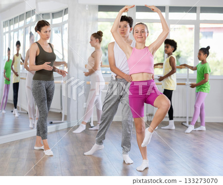 Teenage girl and boy practicing ballet moves in pair in dance studio 133273070