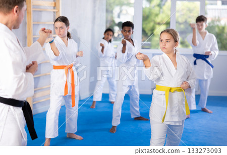 Group of children train karate techniques 133273093