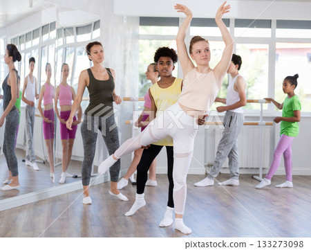 Teenage girl practicing ballet positions in pair with boy in dance studio 133273098