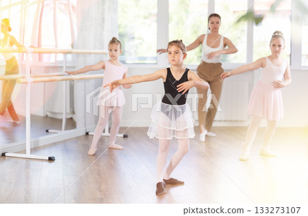 Group of girls rehearsing ballet moves Group of girls rehearsing ballet moves 133273107