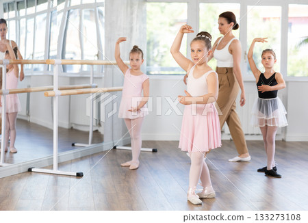 Little girls are learning various dance and ballet movements in studio 133273108