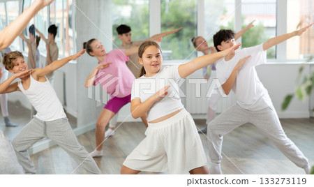 Teenagers in dance hall learn new moves. Contemporary street dance and hip-hop lesson in dance studio 133273119