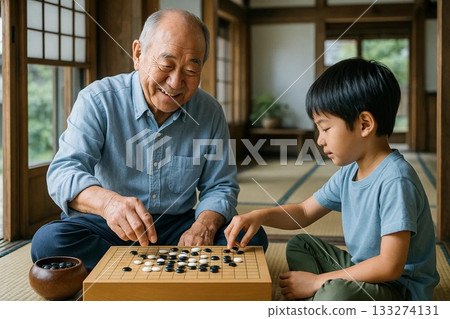 Grandpa and grandson spending time together playing Go in a Japanese-style room 133274131