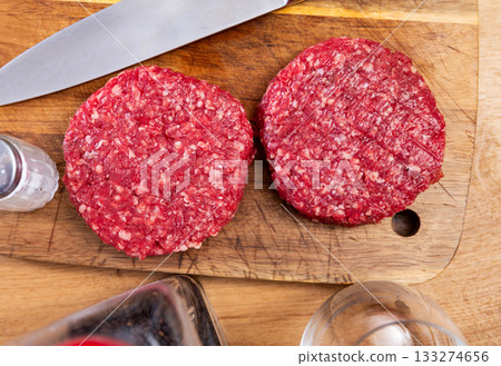Two raw juicy beef burger cutlets are prepared for frying Two raw juicy beef burger cutlets are prepared for frying 133274656