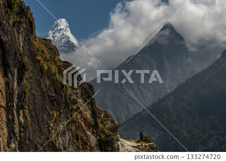 Tourist trekking in Sagarmatha national park, Nepal with beautiful part of Mt.Ama Dablam (6,812 m). Ama Dablam is one of the most beautiful mountains in the world. 133274720