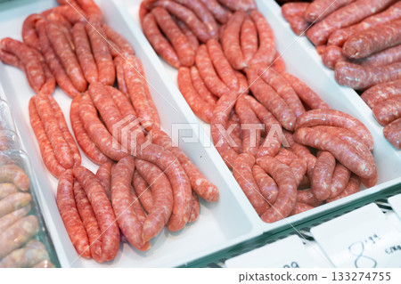 Refrigerator showcase in culinary store - various versions of butifara sausages 133274755