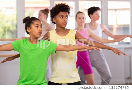 African American teenage pair training in group ballet class African American teenage pair training in group ballet class 133274785