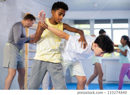 Two boys practicing self-defense techniques Two boys practicing self-defense techniques 133274840
