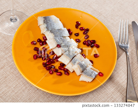 Salted Atlantic herring fillet served with pomegranate seeds Salted Atlantic herring fillet served with pomegranate seeds 133274847