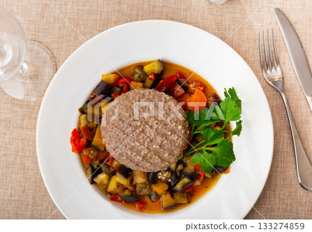 Hamburger patty with vegetables on a plate Hamburger patty with vegetables on a plate 133274859