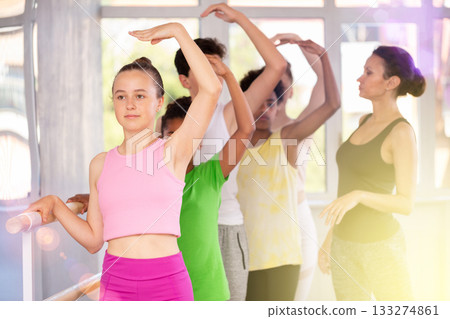 Woman teacher corrects teenagers in first position 133274861