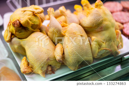 Fresh chickens on display in a supermarket Fresh chickens on display in a supermarket 133274863