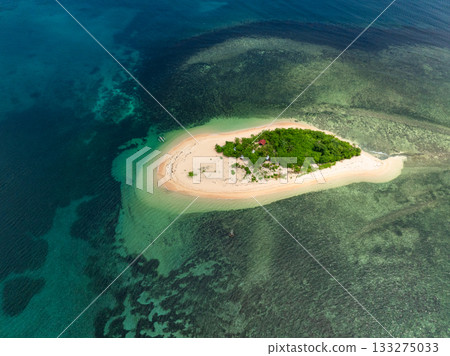 White sand beach in tropical island surrounded by clear turquoise water and coral reef. Siargao, Philippines. Kangkangon Island. 133275033