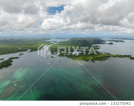 A wide coastal landscape with rivers winding among mangrove islands and distant hills. Siargao, Philippines. 133275042