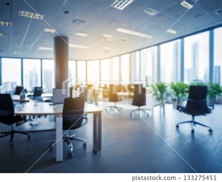 The interior of a modern vacant office with natural light streaming in. A bright workspace with desks and chairs, perfect for corporate and business use. 133275451