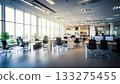 A modern office space featuring large windows and natural light. The bright workspace and neat desk arrangement are attractive for businesses and companies. 133275455