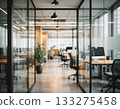 A modern glass-walled corporate office. A bright workspace with natural light streaming in, with a professional desk. 133275458