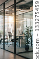A modern office space with glass partitions. A bright workspace and well-organized desks make this a business space. 133275459
