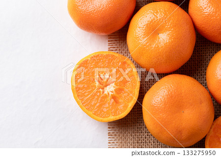 Mandarin orange fruit on brown and white background, Top view 133275950