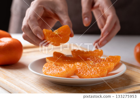 Fresh cut of Mandarin orange fruit preparing on plate ready to eating Fresh cut of Mandarin orange fruit preparing on plate ready to eating 133275953
