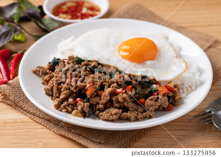 Thai food, Stir fried holy basil with minced pork with cooked rice and fried egg on top Thai food, Stir fried holy basil with minced pork with cooked rice and fried egg on top 133275956