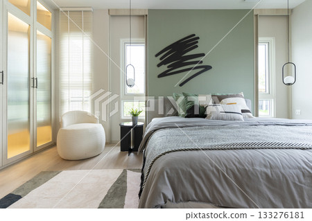 Modern bedroom interior with green wall and wall art with hanging lamp. Modern bedroom interior with green wall and wall art with hanging lamp. 133276181
