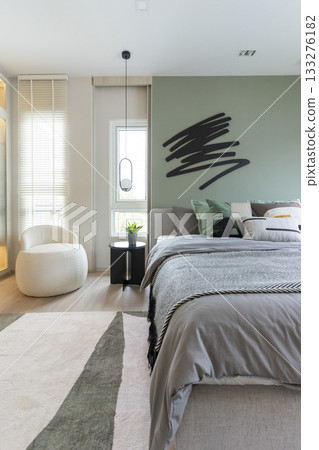 Modern bedroom interior with green wall and wall art with hanging lamp. Modern bedroom interior with green wall and wall art with hanging lamp. 133276182