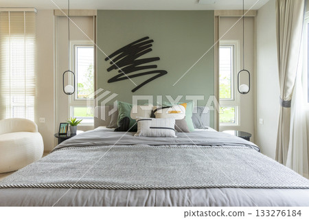 Modern bedroom interior with green wall and wall art with hanging lamp. Modern bedroom interior with green wall and wall art with hanging lamp. 133276184